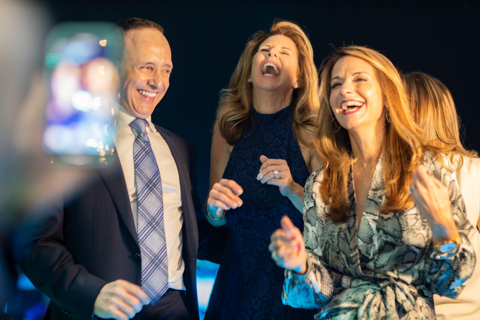 Guests laughing together during the celebration