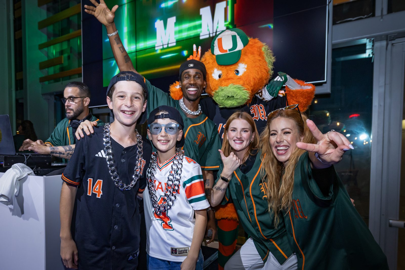 Kids celebrating with the University of Miami mascot