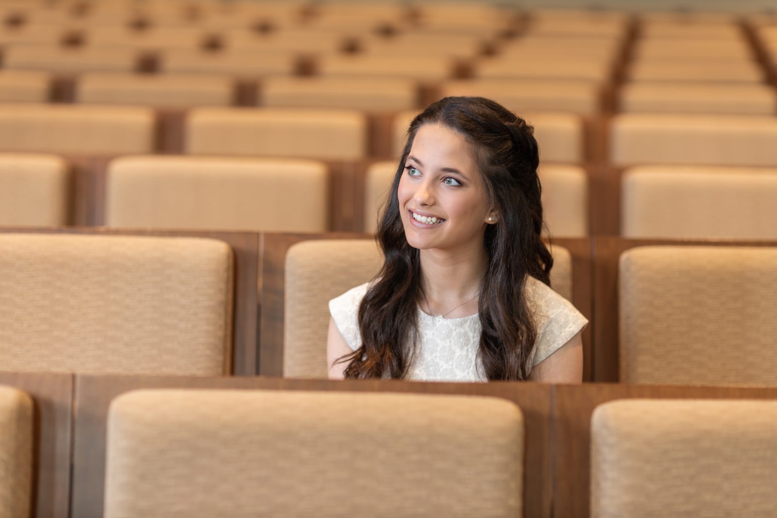 Bat mitzvah girl seated in the temple sanctuary