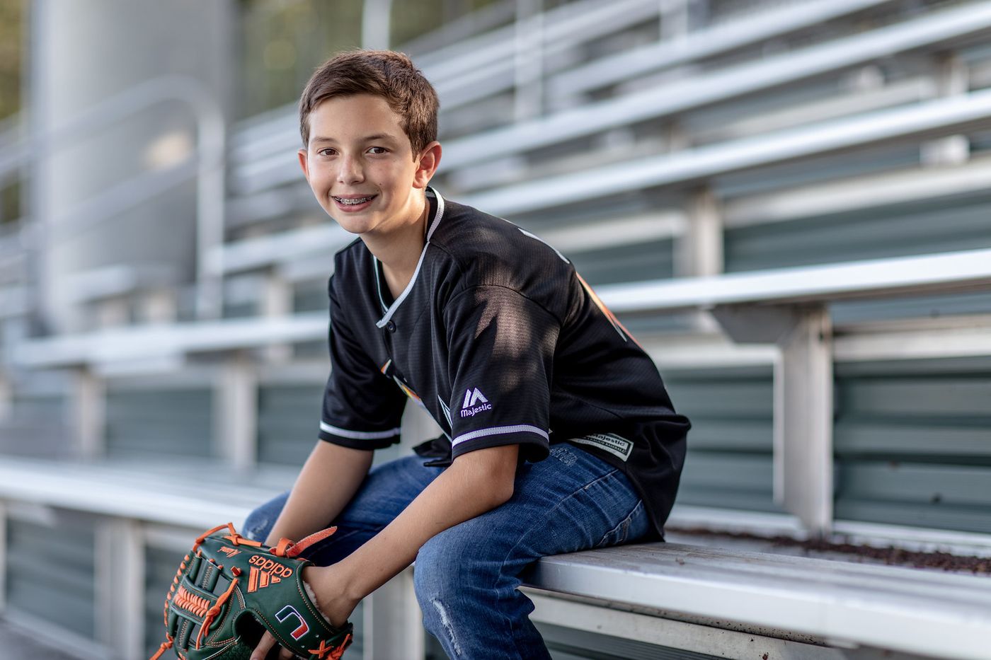 Boy sitting on stadium bleachers