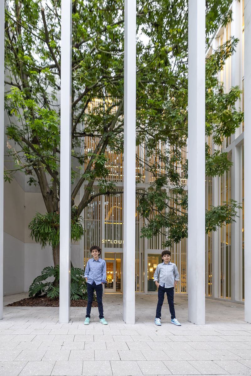 Modern architectural columns with kids walking beneath