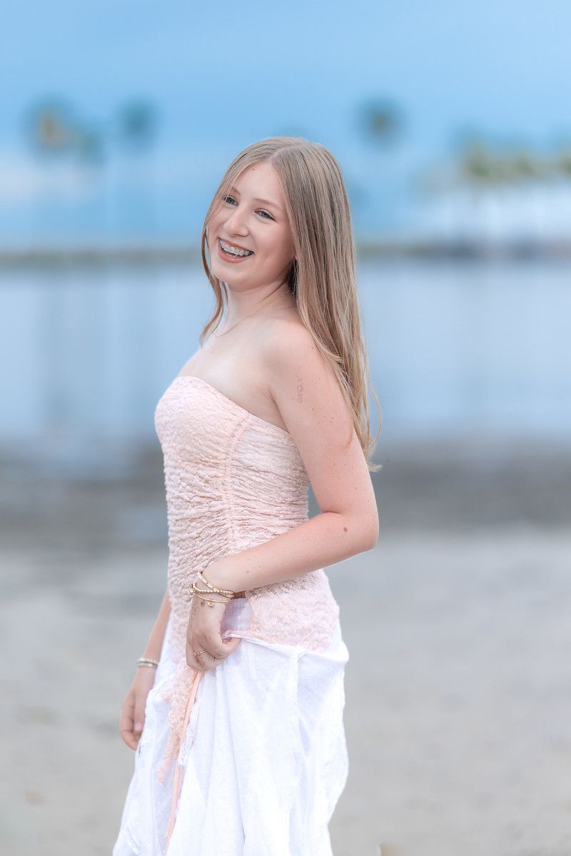 Girl in a white dress by the water in soft light