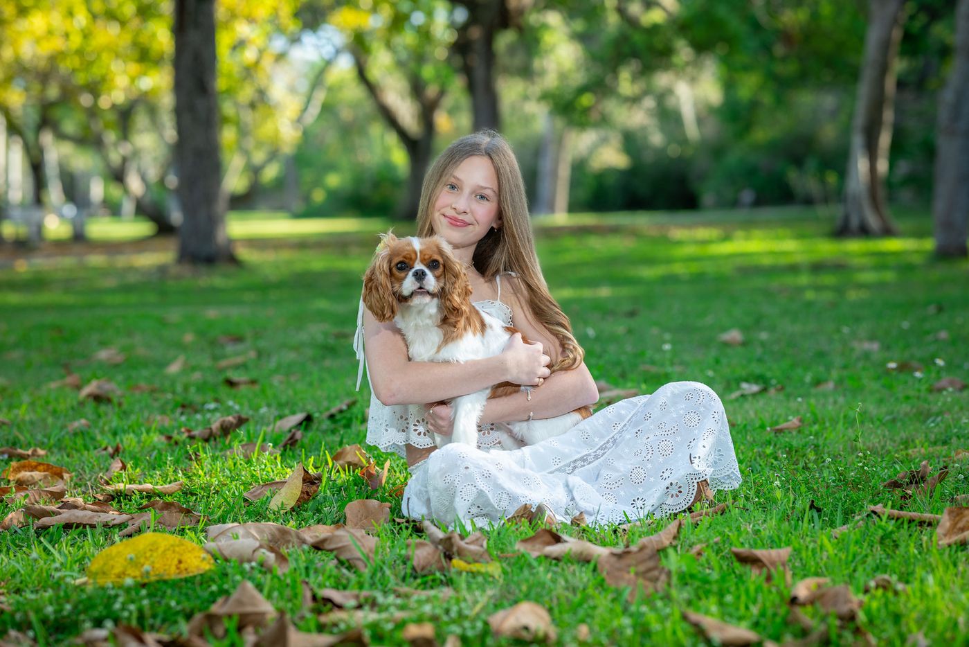 Girl sitting on the grass with the family dog